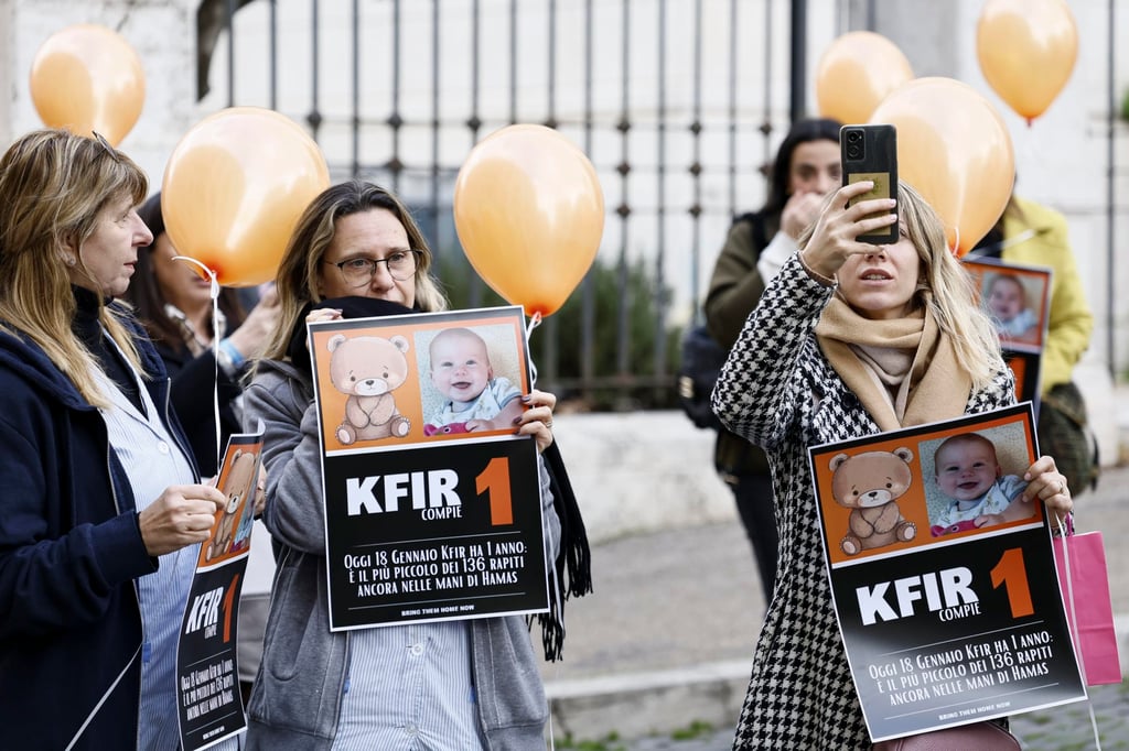 Protesters hold placards during a flash mob to mark the first birthday of Israeli toddler Kfir Bibas, who is held hostage by Hamas in Gaza, in Rome, Italy on Thursday. Photo: EPA-EFE/ Protesters hold placards during a flash mob to mark the first birthday of Israeli toddler Kfir Bibas, who is held hostage by Hamas in Gaza, in Rome, Italy on Thursday. Photo: EPA-EFE/