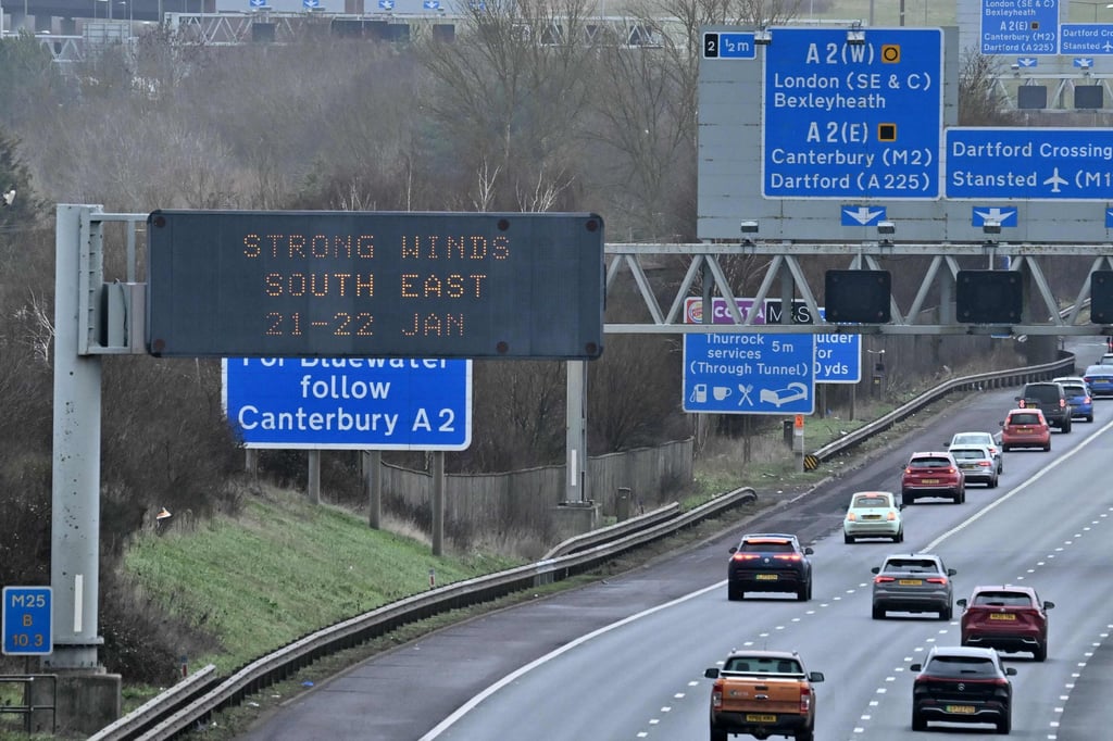 Warning signs for strong winds on the M25 motorway near Swanley, south of London on Sunday. Photo: AFP