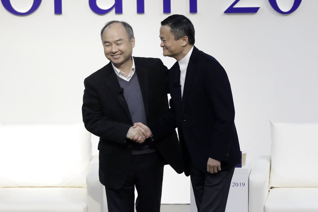 Masayoshi Son, the founder, chairman and chief executive of SoftBank Group Corp, left, and Alibaba Group Holding founder Jack Ma shake hands at Tokyo Forum 2019 in Japan on December 6, 2019. Photo: Bloomberg