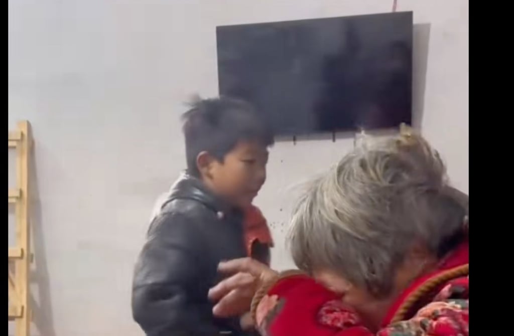 The youngster and his tearful grandmother were captured on video after the brave boy pulled her out of their blazing home. Photo: Douyin The youngster and his tearful grandmother were captured on video after the brave boy pulled her out of their blazing home. Photo: Douyin
