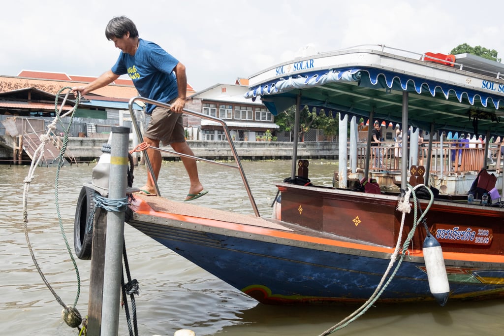 Mr Tai ties up his solar-powered boat, the Sol Solar, on the Thonburi side of the Chao Phraya River, Bangkok, Thailand. Photo: Oliver Raw Mr Tai ties up his solar-powered boat, the Sol Solar, on the Thonburi side of the Chao Phraya River, Bangkok, Thailand. Photo: Oliver Raw