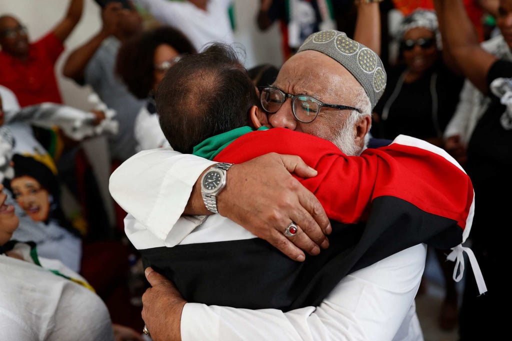 Pro-Palestinian supporters celebrate in the embassy of Palestine in Pretoria on Friday after watching the International Court of Justice delivering its decision on the case against Israel brought by South Africa. Photo: AFP