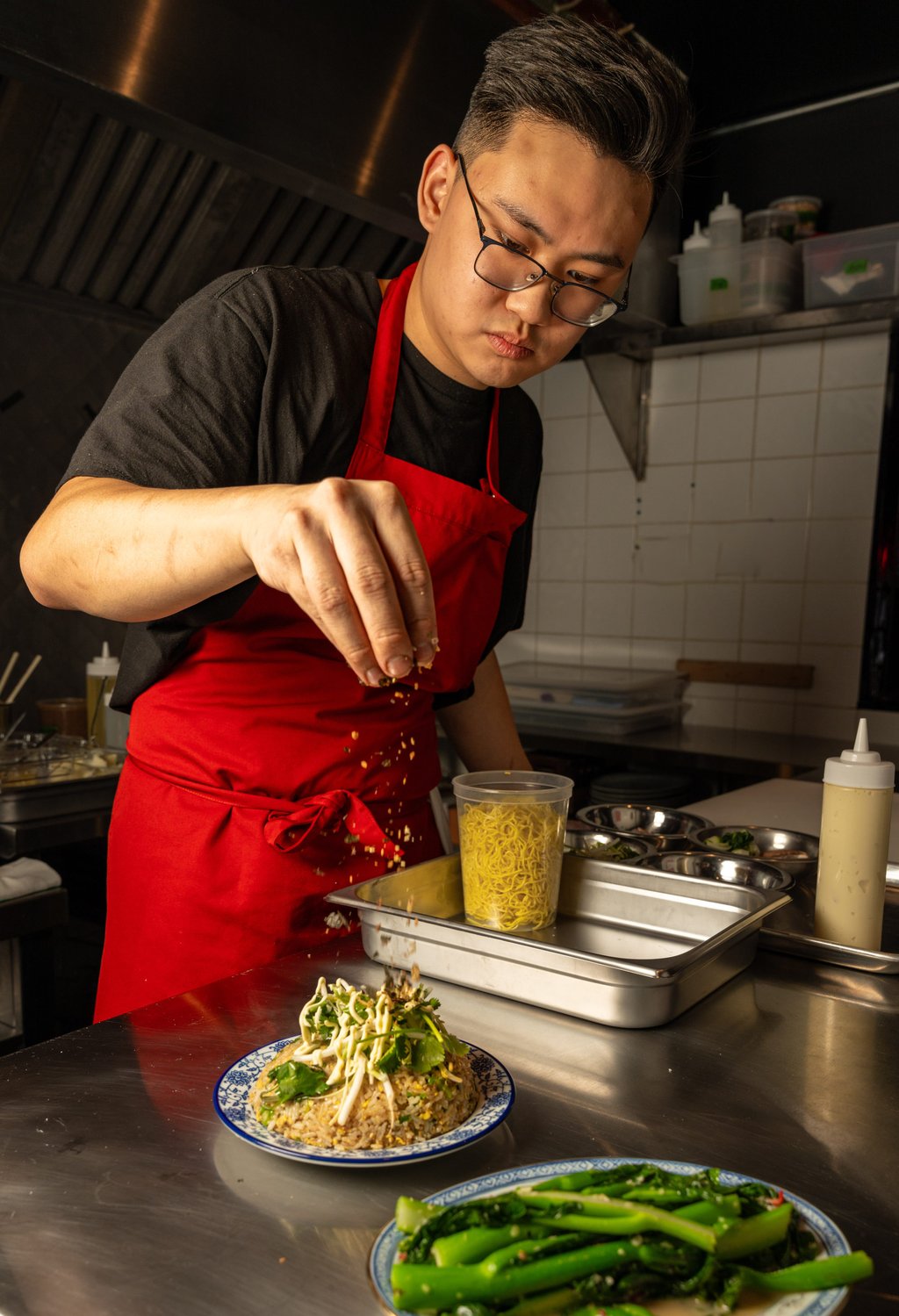 Lee puts the finishing touches to a dish at Oncle Lee. Photo: Scott Usheroff Lee puts the finishing touches to a dish at Oncle Lee. Photo: Scott Usheroff