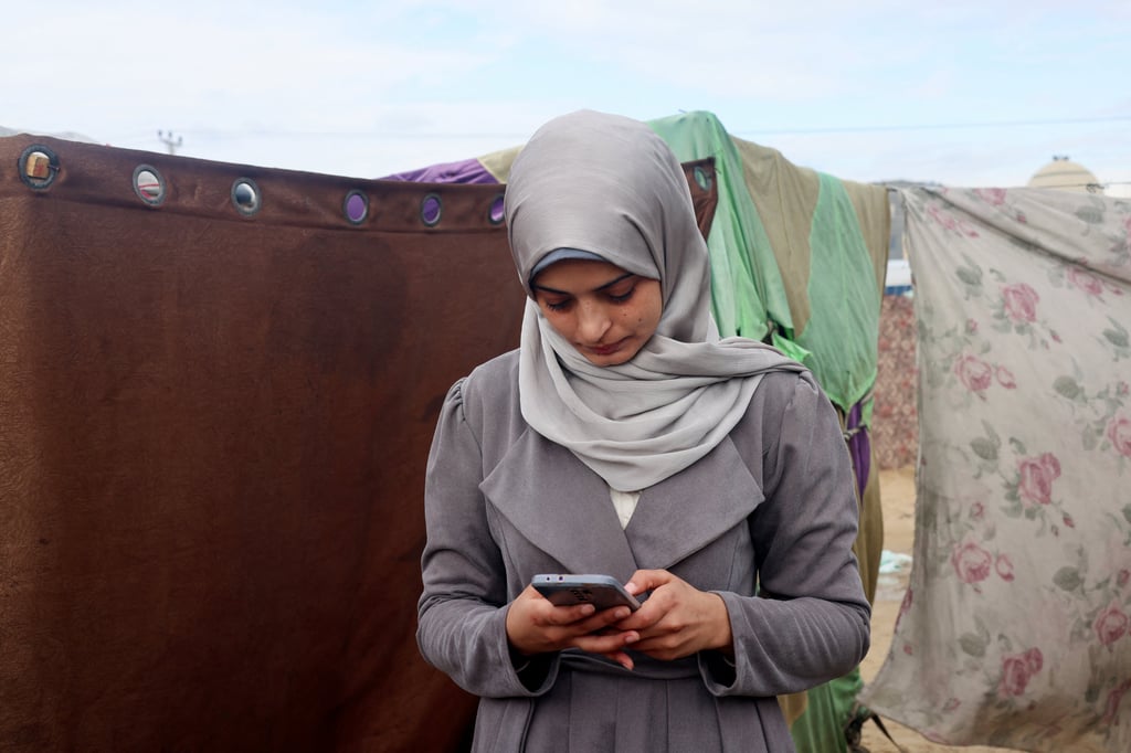 Aseel Abu Haddaf, a Palestinian medical student who fled her house in Khan Younis, now spends much of her day cleaning the family tent, washing clothes and cooking the little food they can find. Photo: Reuters Aseel Abu Haddaf, a Palestinian medical student who fled her house in Khan Younis, now spends much of her day cleaning the family tent, washing clothes and cooking the little food they can find. Photo: Reuters