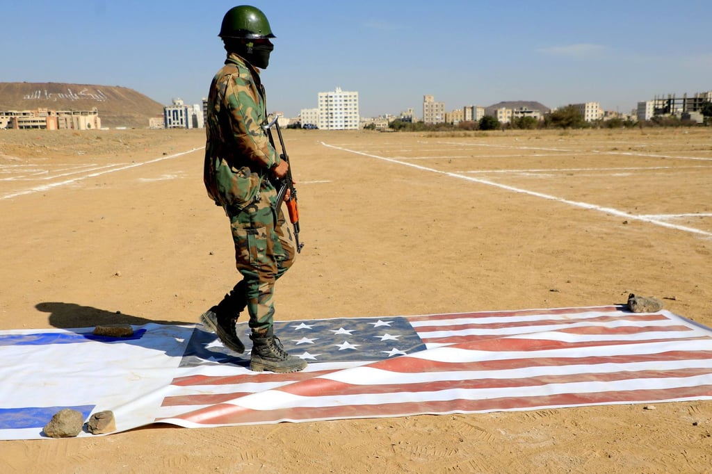 A Yemeni Houthi fighter walks on the flags of Israel and the US during a rally the Iran-backed group held in Sanaa in solidarity with the Palestinian Hamas movement’s armed resistance against Israel on Monday. Photo: AFP A Yemeni Houthi fighter walks on the flags of Israel and the US during a rally the Iran-backed group held in Sanaa in solidarity with the Palestinian Hamas movement’s armed resistance against Israel on Monday. Photo: AFP