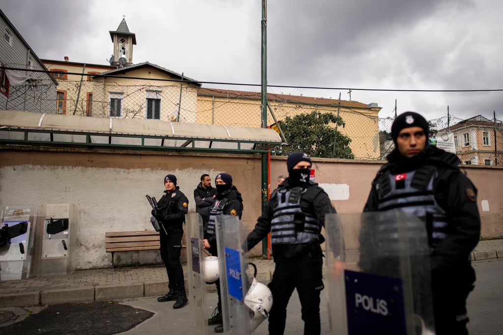 Turkish police officers stand guard outside the Santa Maria church in Istanbul, Turkey on Sunday. Photo: AP Turkish police officers stand guard outside the Santa Maria church in Istanbul, Turkey on Sunday. Photo: AP