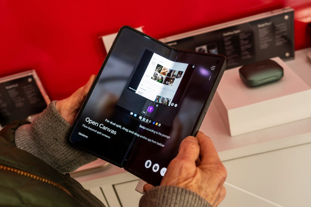 A visitor tries out the OnePlus Open foldable smartphone during the Chinese firm’s brand-activation event in New York on November 3, 2023. Photo: Shutterstock