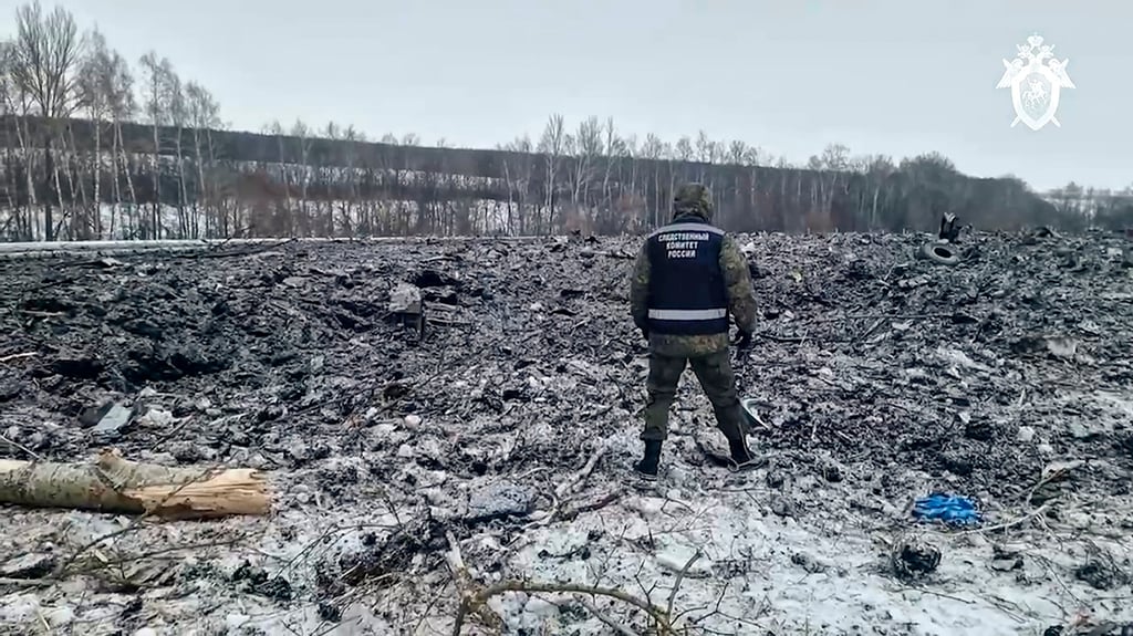 An investigator walks in a field where a Russian military transport plane crashed in the Belgorod region of Russia. Photo: Russian Investigative Committee via AP An investigator walks in a field where a Russian military transport plane crashed in the Belgorod region of Russia. Photo: Russian Investigative Committee via AP