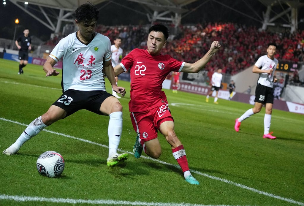 Hong Kong Jesse Yu (right) and Guangdong’s Cui Wei tussle for the ball during the game at Mong Kok Stadium. Photo: Elson Li