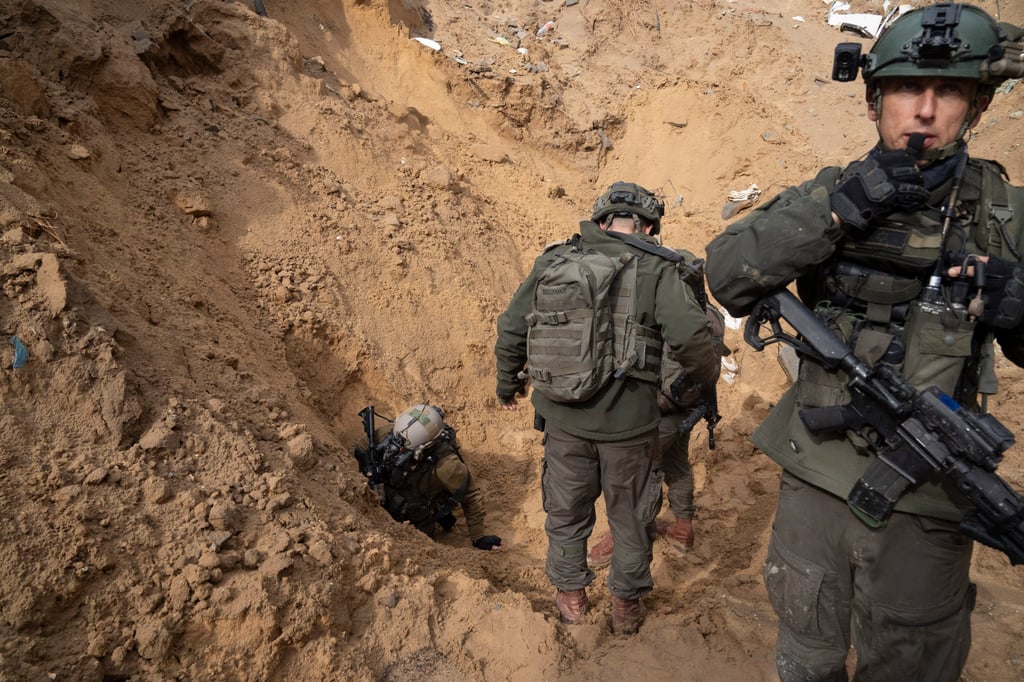 Israeli soldiers enter a Hamas tunnel underneath a cemetery during the ground offensive on the Gaza Strip in Khan Younis on Saturday. Photo: AP