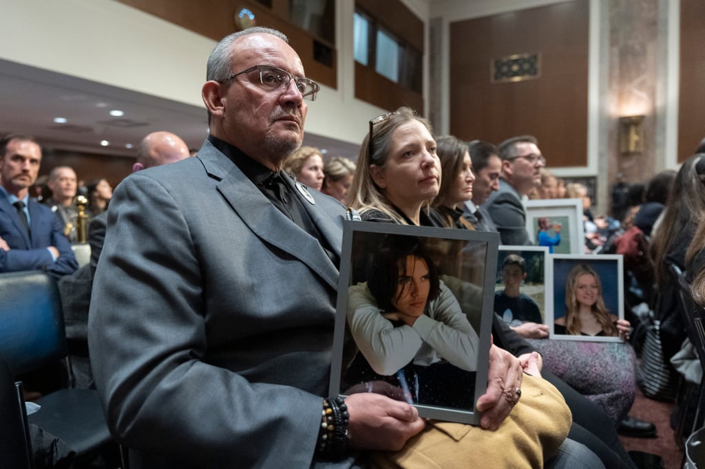 Jaime Puerta, of Santa Clarita, California, holds a picture of his son Daniel Joseph Puerta-Johnson, during a Senate Judiciary Committee hearing on Capitol Hill on Wednesday. Photo: AP