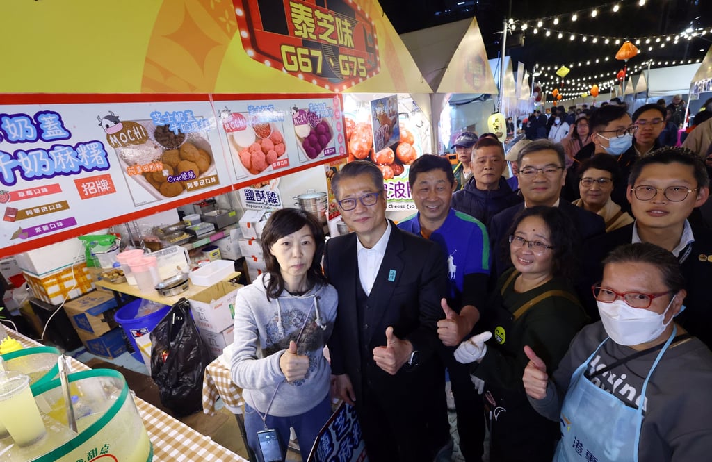 Paul Chan (second from left) at a Lunar New Year night market last week. The finance chief has expressed an optimistic outlook for the city’s economy for the Year of the Dragon. Photo: Dickson Lee
