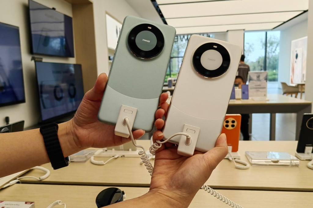 A shopper holds up two display units of Huawei Technologies’ 5G Mate 60 Pro smartphone at an electronics store in Xian, capital of northwestern Shaanxi province, on September 9, 2023. Photo: Shutterstock