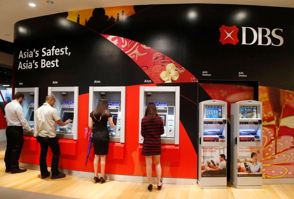 People use DBS ATMs in Singapore. Albertina had been entrusted with her employer’s account details to make her own salary transfers, the court heard. Photo: Reuters