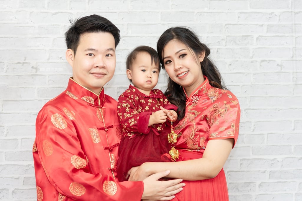 To ensure good luck in the year to come, wear red clothing that’s new at Chinese New Year, like this family. Photo: Shutterstock