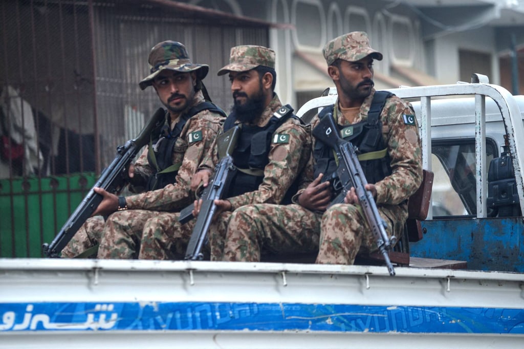 Armed soldiers on patrol in Karachi on Thursday as voting begins in Pakistan’s national elections. Photo: AFP