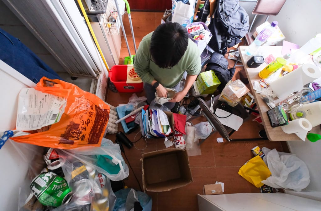 Mercy Wong, 28, cleaning up his 150 sq ft flat ahead of Lunar New Year. Photo: Sun Yeung