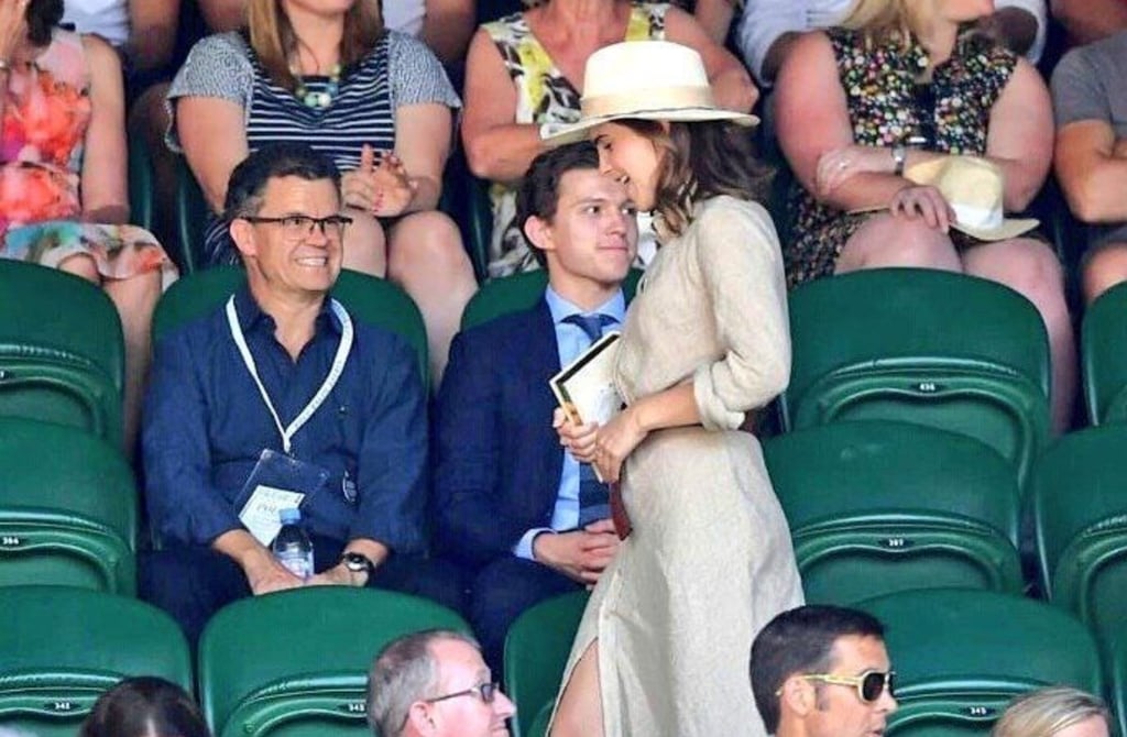Tom Holland (right) sitting with his dad, Dominic Holland (left). Photo: @dommoholland/Instagram
