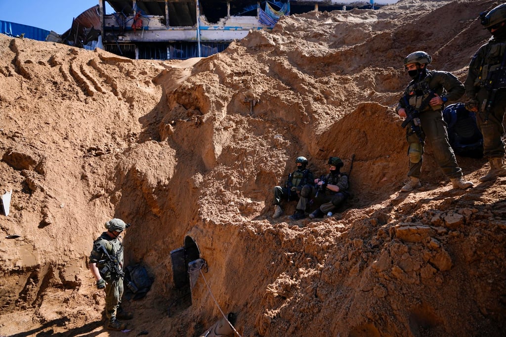 Israeli soldiers guard a crater-like hole giving way to a small tunnel entrance in the UNRWA compound in Gaza on Thursday. Photo: AP