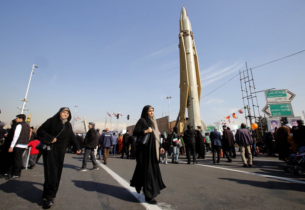 Iranians in Tehran walk next to a long range missile on Sunday as they celebrate the 45th anniversary of the Islamic Revolution. Photo: EPA-EFE Iranians in Tehran walk next to a long range missile on Sunday as they celebrate the 45th anniversary of the Islamic Revolution. Photo: EPA-EFE