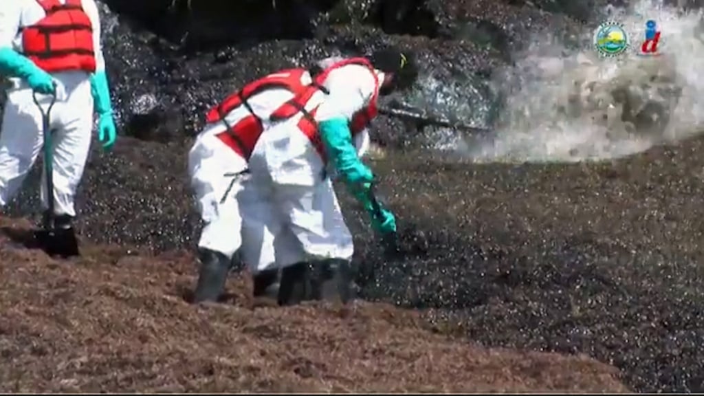 This video grab released by the Tobago House Assembly shows emergency workers trying to deal with an oil spill after a ship capsized. Photo: Handout via AFP This video grab released by the Tobago House Assembly shows emergency workers trying to deal with an oil spill after a ship capsized. Photo: Handout via AFP