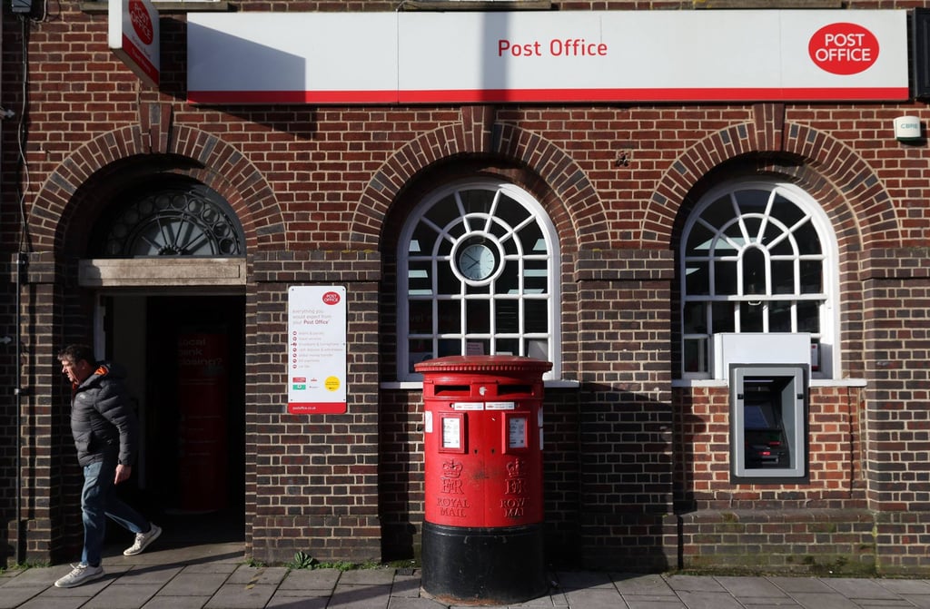 A customer exits a Post Office branch in England. Fujitsu supplied post offices with its Horizon software, which contained bugs. Photo: AFP