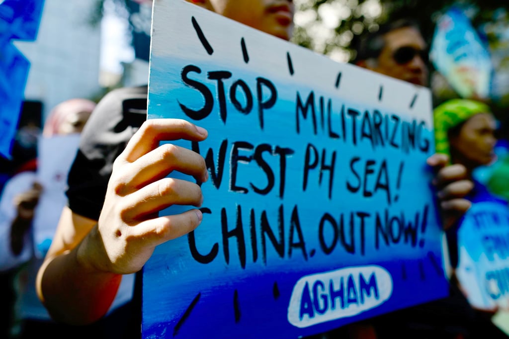 Protesters hold placards during a rally outside the Chinese consular office in Manila last week. Filipino fishermen said the demonstration was organised to condemn China’s harassment of Filipino fishermen in the South China Sea. Photo: EPA-EFE