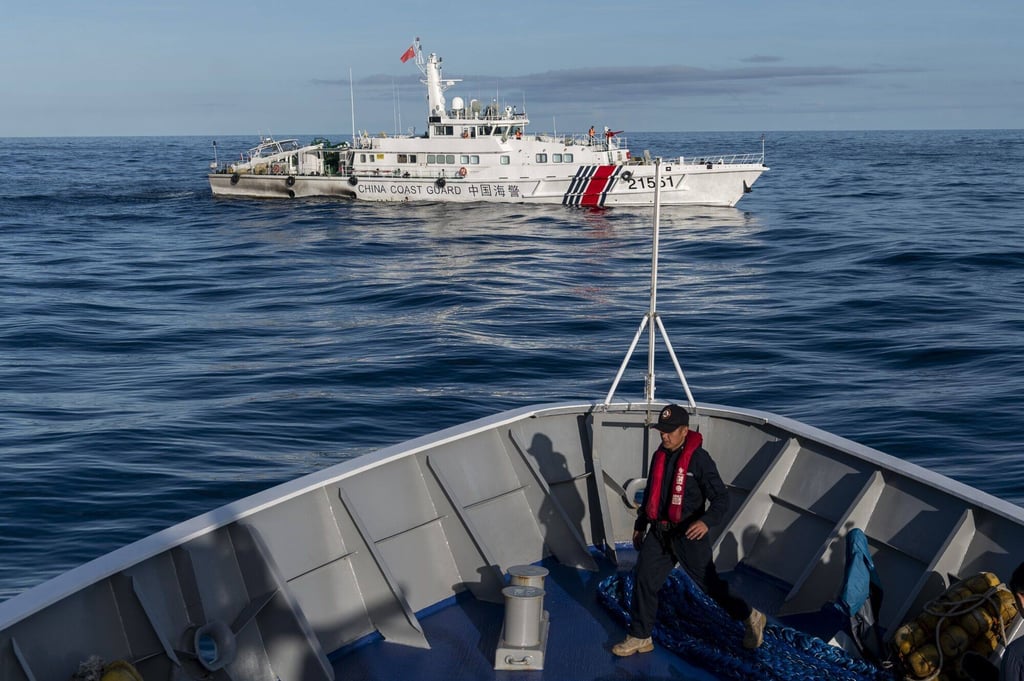 A China Coast Guard ship moves past a Philippine Coast Guard vessel BRP Sindangan in the disputed Second Thomas Shoal, in the South China Sea. Photo: Bloomberg A China Coast Guard ship moves past a Philippine Coast Guard vessel BRP Sindangan in the disputed Second Thomas Shoal, in the South China Sea. Photo: Bloomberg