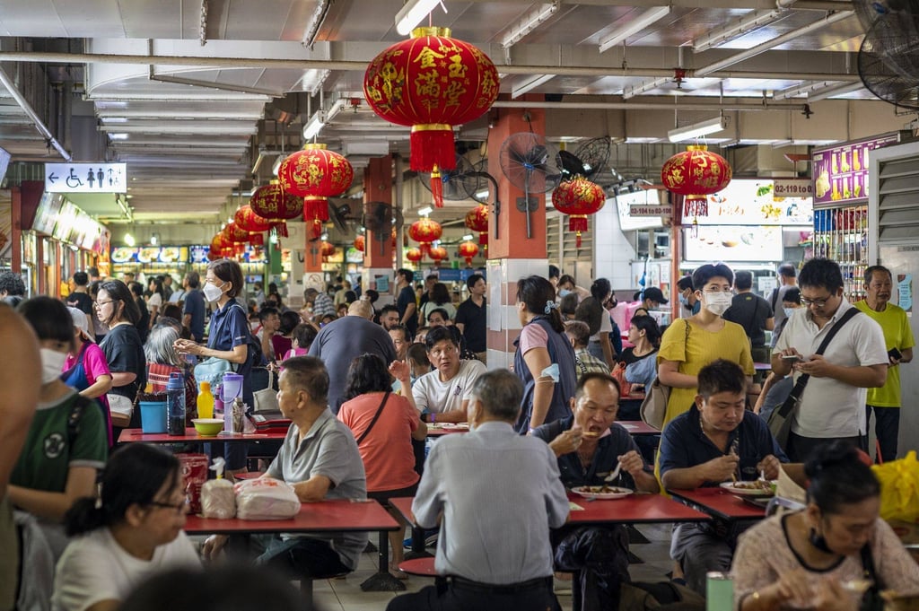 Customers have lunch at Chinatown Complex Food Centre in Singapore. Headline inflation has fallen from a peak of 5.5 per cent a year ago, but it remained higher than pre-pandemic levels, at 3.3 per cent in December. Photo: Bloomberg Customers have lunch at Chinatown Complex Food Centre in Singapore. Headline inflation has fallen from a peak of 5.5 per cent a year ago, but it remained higher than pre-pandemic levels, at 3.3 per cent in December. Photo: Bloomberg