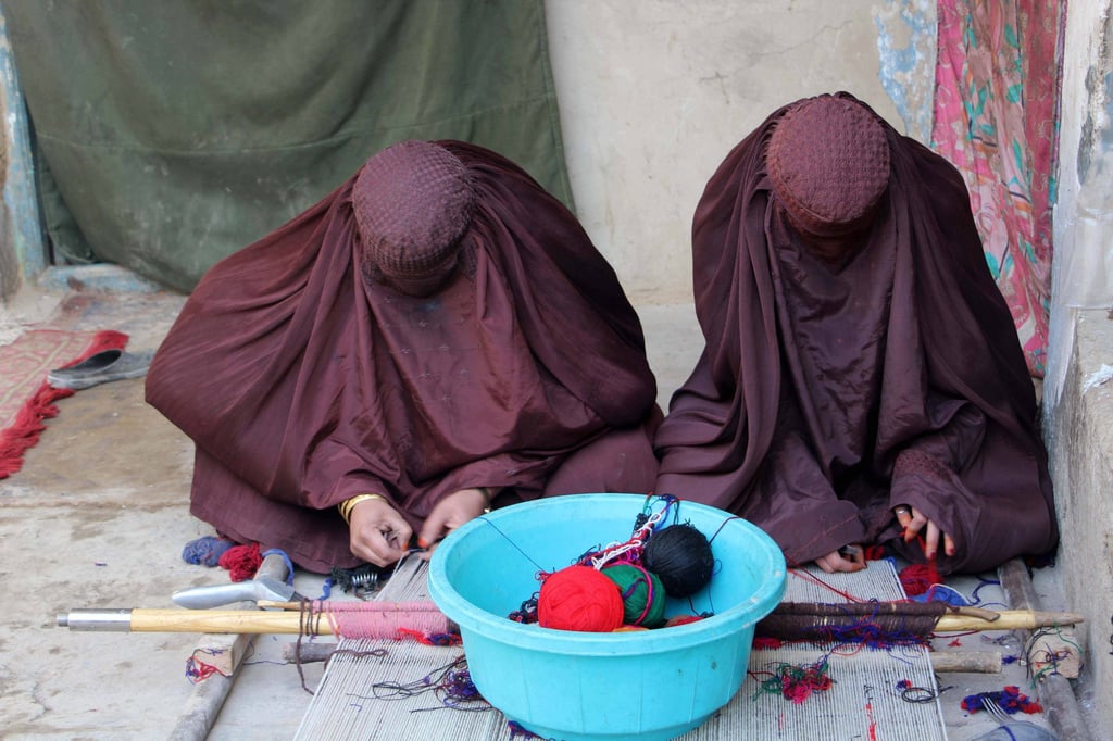 Afghan women work at a carpet loom at a home in Kandahar. Photo: EPA-EFE Afghan women work at a carpet loom at a home in Kandahar. Photo: EPA-EFE