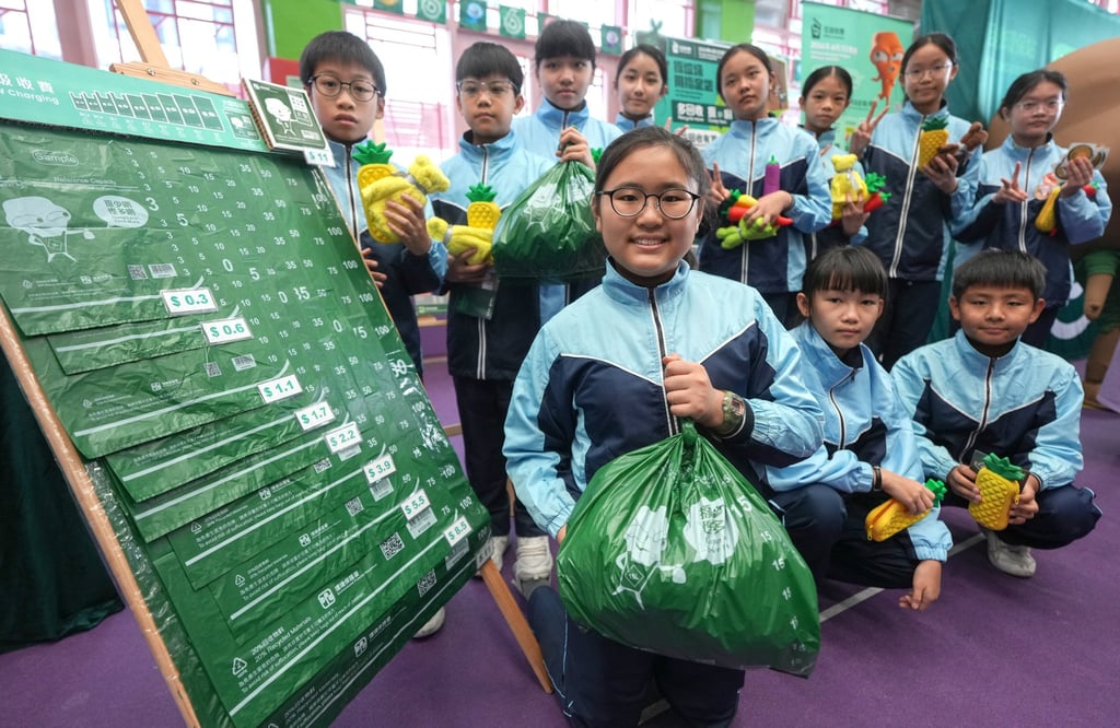 Pupils learn how to use designated bags at a promotional event for the waste-charging scheme. Photo: Eugene Lee