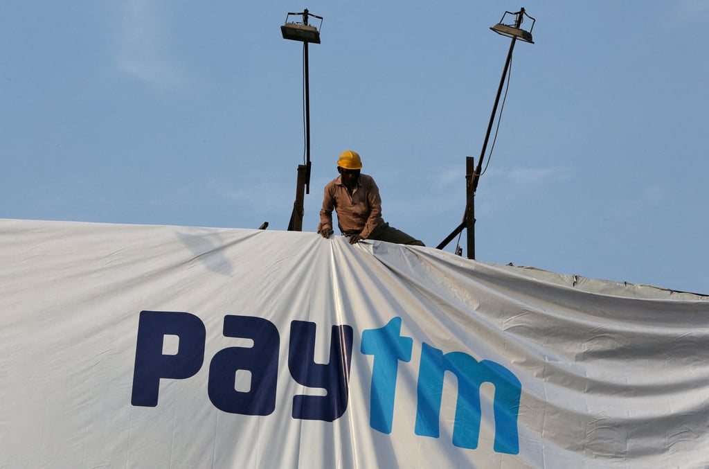A worker adjusts a hoarding of Paytm, a digital payments firm, in Ahmedabad. Paytm is grappling with a crisis rooted in persistent non-compliance. Photo: Reuters A worker adjusts a hoarding of Paytm, a digital payments firm, in Ahmedabad. Paytm is grappling with a crisis rooted in persistent non-compliance. Photo: Reuters