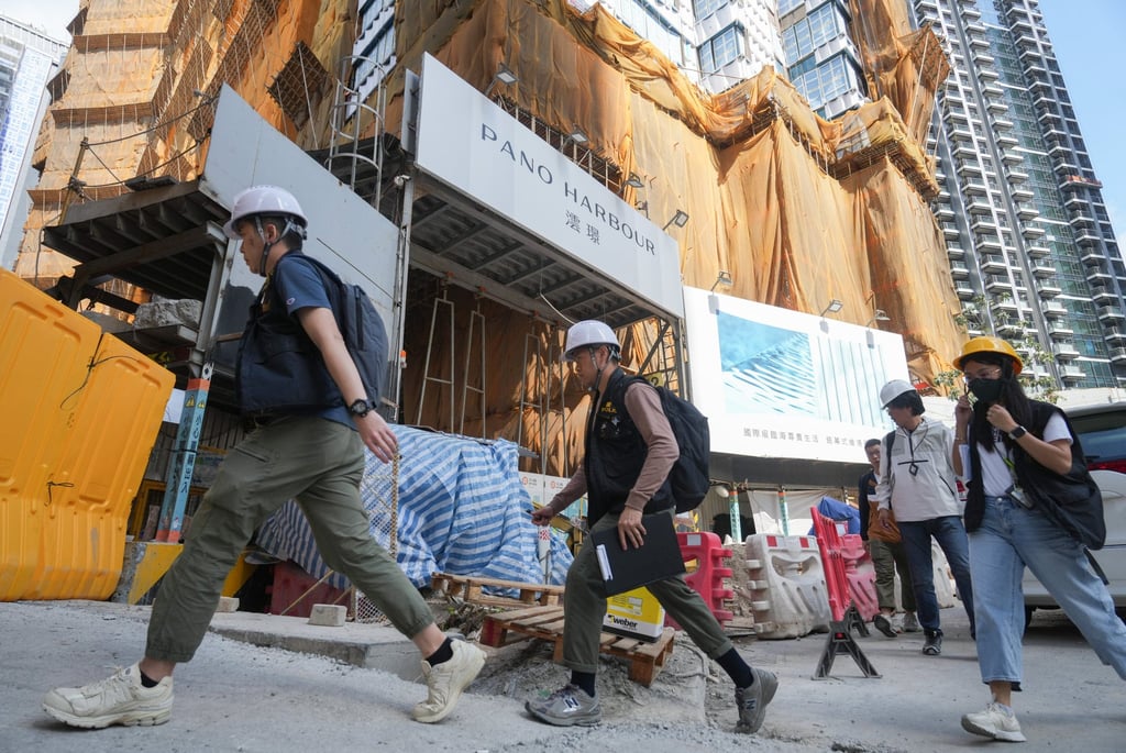 Officers from the Labour Department and Buildings Department inspect the Kai Tak site where the bamboo scaffolding collapsed. Photo: Sam Tsang