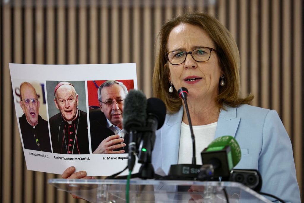 Marko Rupnik (third from left) is pictured in a document held by Anne Barrett Doyle, co-director of the abuse tracking site Bishop Accountability, at a press conference in Rome, Italy, on Wednesday. Photo: Reuters Marko Rupnik (third from left) is pictured in a document held by Anne Barrett Doyle, co-director of the abuse tracking site Bishop Accountability, at a press conference in Rome, Italy, on Wednesday. Photo: Reuters