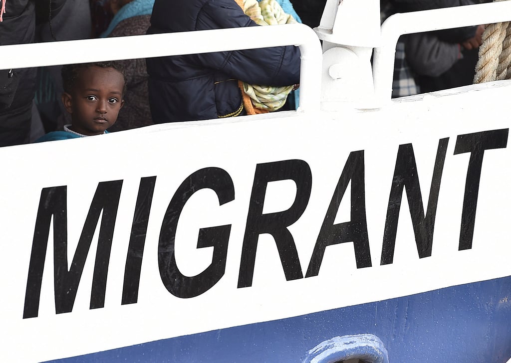 Achild waits to disembark with 400 other migrants in the harbour of Messina, Sicily, Southern Italy. Photo: AP Achild waits to disembark with 400 other migrants in the harbour of Messina, Sicily, Southern Italy. Photo: AP