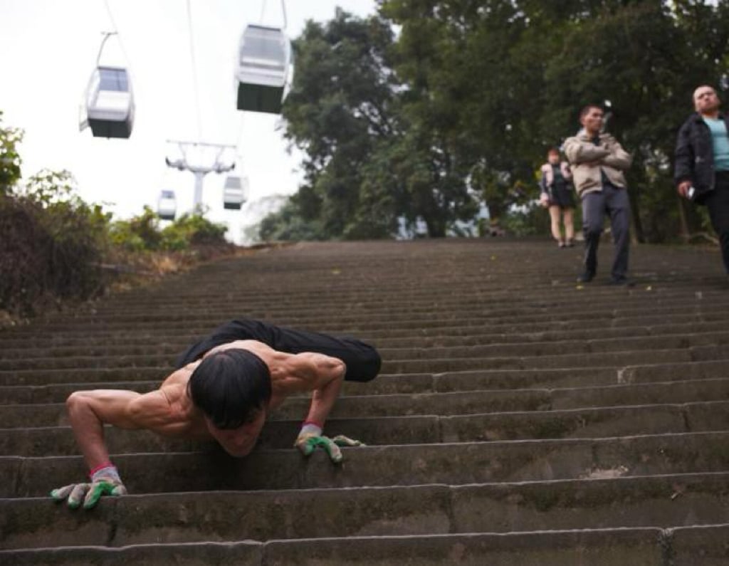 The 70-year-old uses a self-styled, alligator-style crawling technique to make his way down the mountain. Photo: Shangyou News The 70-year-old uses a self-styled, alligator-style crawling technique to make his way down the mountain. Photo: Shangyou News