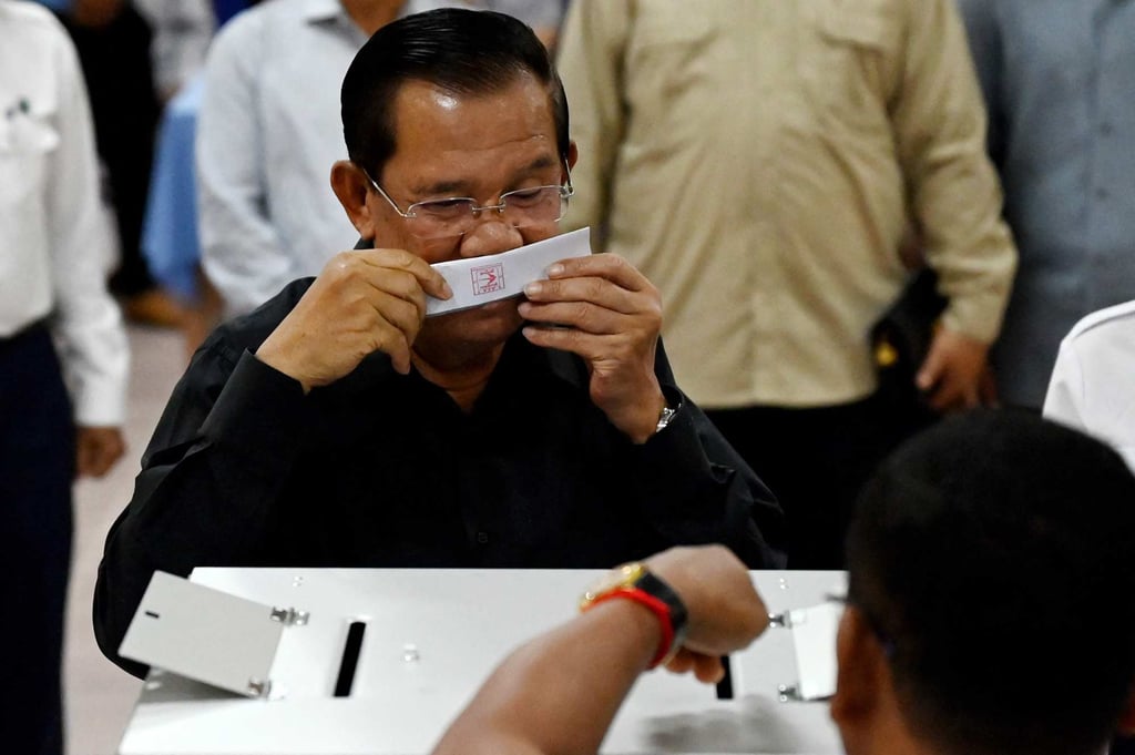 Former prime minister Hun Sen kisses the ballot paper as he casts his vote at a polling station during the Senate election in Takhmao city, Kandal province, on Sunday. Photo: AFP Former prime minister Hun Sen kisses the ballot paper as he casts his vote at a polling station during the Senate election in Takhmao city, Kandal province, on Sunday. Photo: AFP