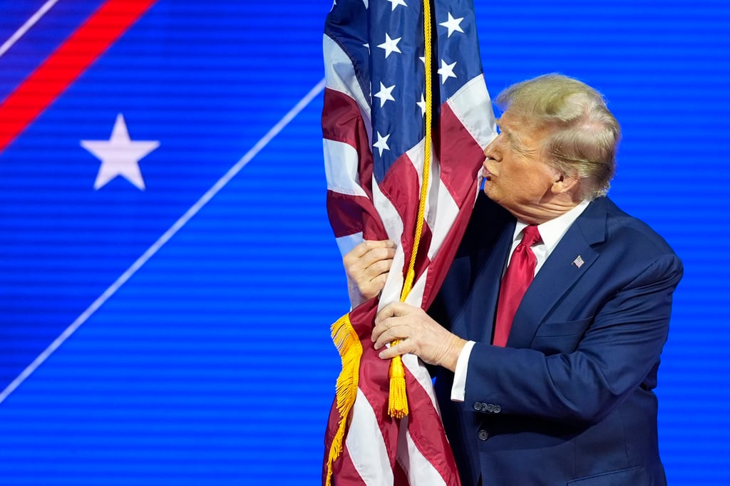 Donald Trump kisses the US flag at last week’s Conservative Political Action Conference in Oxon Hill, Maryland. Photo: AP Donald Trump kisses the US flag at last week’s Conservative Political Action Conference in Oxon Hill, Maryland. Photo: AP