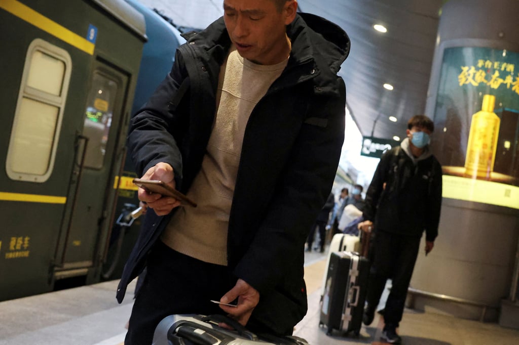 A traveller checks his smartphone at the Beijing West railway station. Photo: Reuters A traveller checks his smartphone at the Beijing West railway station. Photo: Reuters