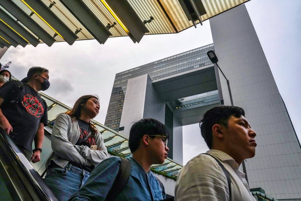People walk through the bridge connecting Tamar and the MTR station. Authorities say the stricter handling of serious misconduct cases was the main reason behind the surge in sackings. Photo: Elson Li People walk through the bridge connecting Tamar and the MTR station. Authorities say the stricter handling of serious misconduct cases was the main reason behind the surge in sackings. Photo: Elson Li