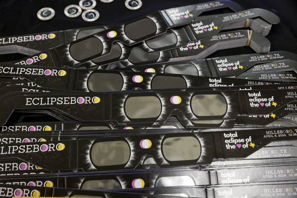 “Eclipseboro”-branded eclipse viewing glasses are seen before a town hall meeting in Hillsboro, Texas. Photo: TNS