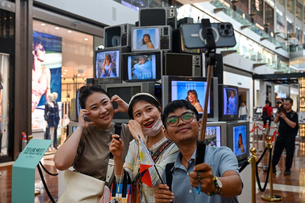 Swifties take pictures next to an installation at the Marina Bay Sands complex in Singapore on February 28. Photo: AFP
