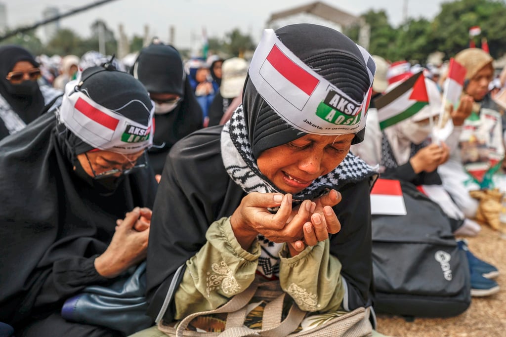 A Muslim woman weeps as she prays during a rally in Jakarta in October last year in support of the Palestinian people. Photo: EPA-EFE A Muslim woman weeps as she prays during a rally in Jakarta in October last year in support of the Palestinian people. Photo: EPA-EFE