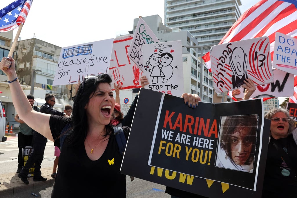 A woman holds a placard bearing the image of 19-year-old Israeli hostage Karina Ariev as relatives and supporters of Israeli captives held in Gaza protest in front of the Branch Office of the US embassy in Tel Aviv on Friday. Photo: AFP A woman holds a placard bearing the image of 19-year-old Israeli hostage Karina Ariev as relatives and supporters of Israeli captives held in Gaza protest in front of the Branch Office of the US embassy in Tel Aviv on Friday. Photo: AFP
