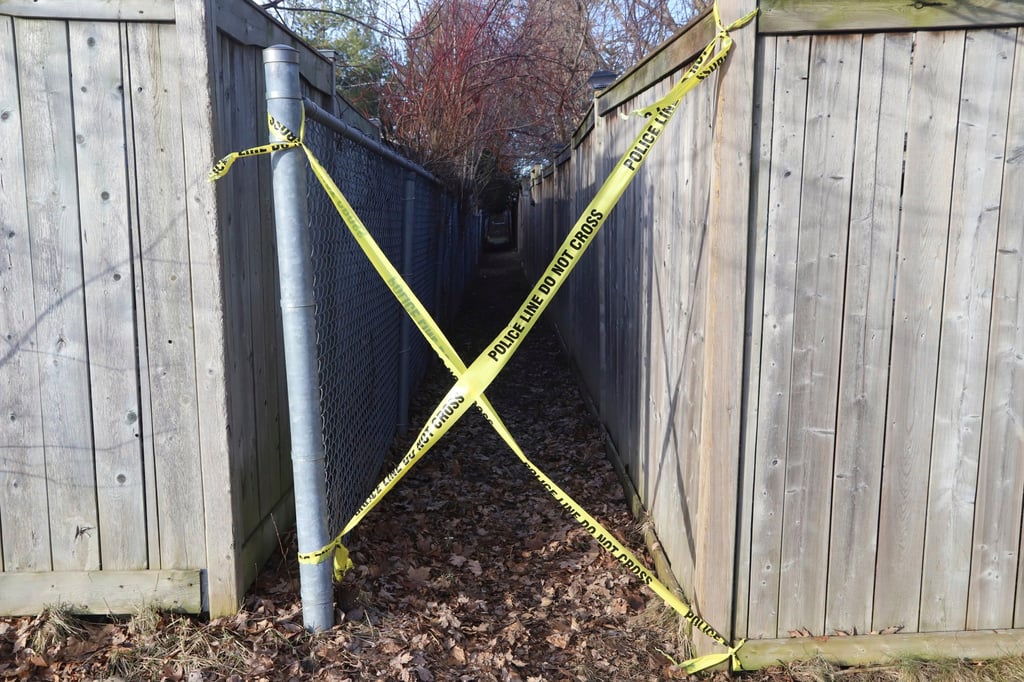 Police tape blocks access to an alleyway at the scene where six people were found dead in the Barrhaven suburb of Ottawa on Thursday. Photo: Canadian Press via AP