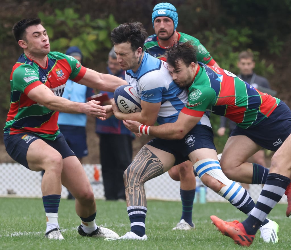 HKFC’s Westyn Cobb is smothered as Sandy Bay almost foiled his team’s title bid. Photo: Yik Yeung-man