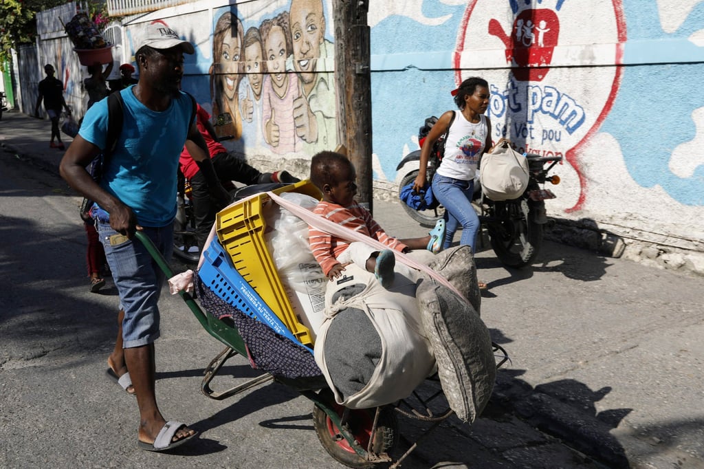 Residents flee their homes during clashes between police and gang members in Port-au-Prince on Saturday. Photo: AP Residents flee their homes during clashes between police and gang members in Port-au-Prince on Saturday. Photo: AP