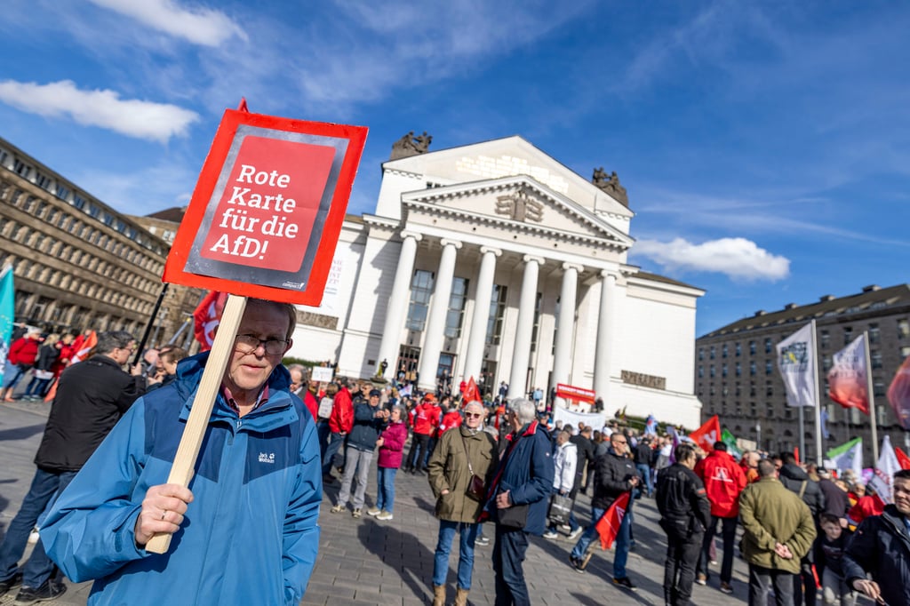 A man carries a sign reading ‘Red card for the AfD’ during a protest against the Alternative for Germany (AfD) party on March 2. Photo: dpa