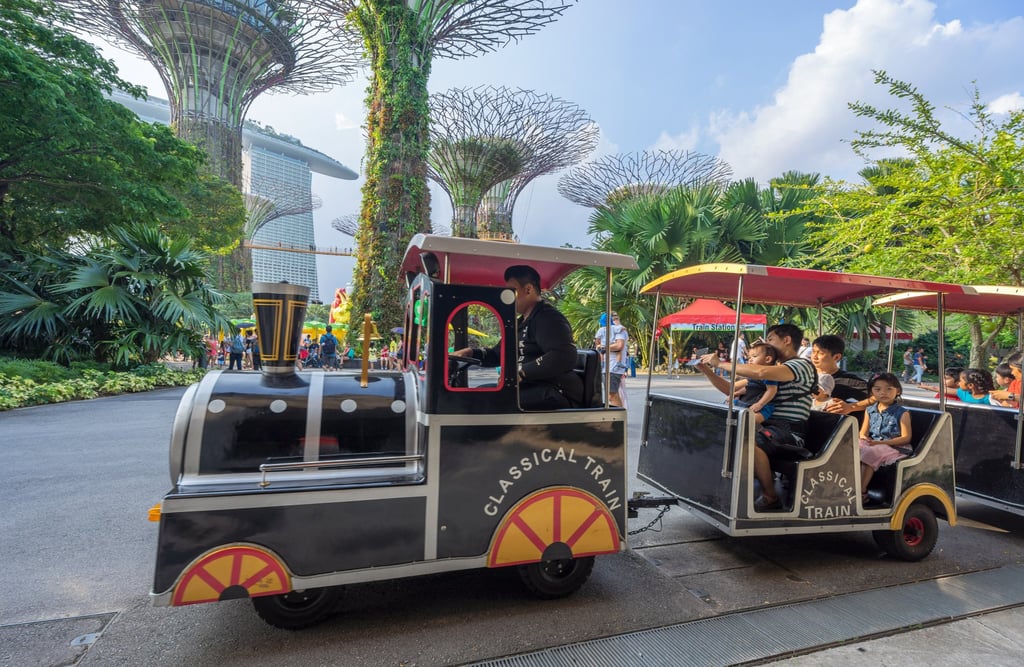 People enjoy a train ride with their children at Gardens By The Bay in Singapore. Photo: Shutterstock