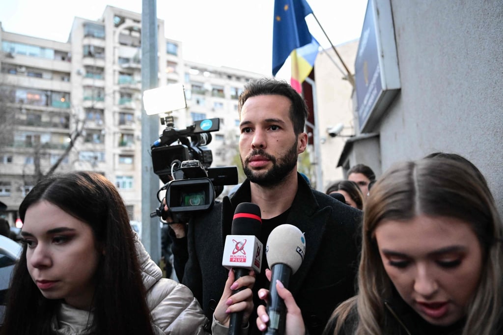 Tristan Tate (centre) is followed by journalists after being released from detention in Bucharest, Romania, on Tuesday. Photo: AFP
